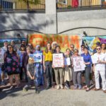 A group standing in front of a sign that says Graham