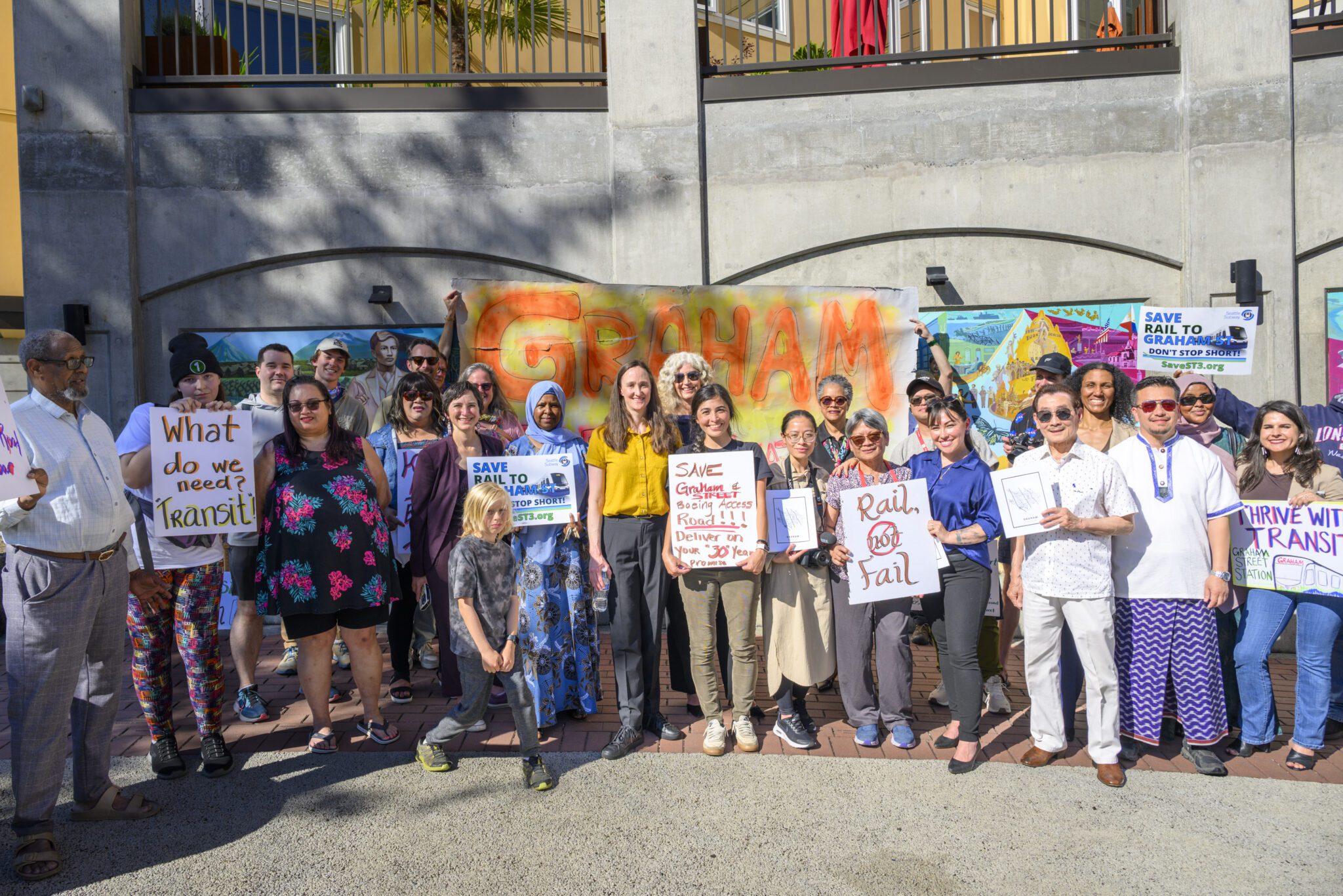 A group standing in front of a sign that says Graham