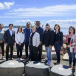 mayor wilson, elected leaders, and philanthropic partners standing in front of blue sky at waterfront